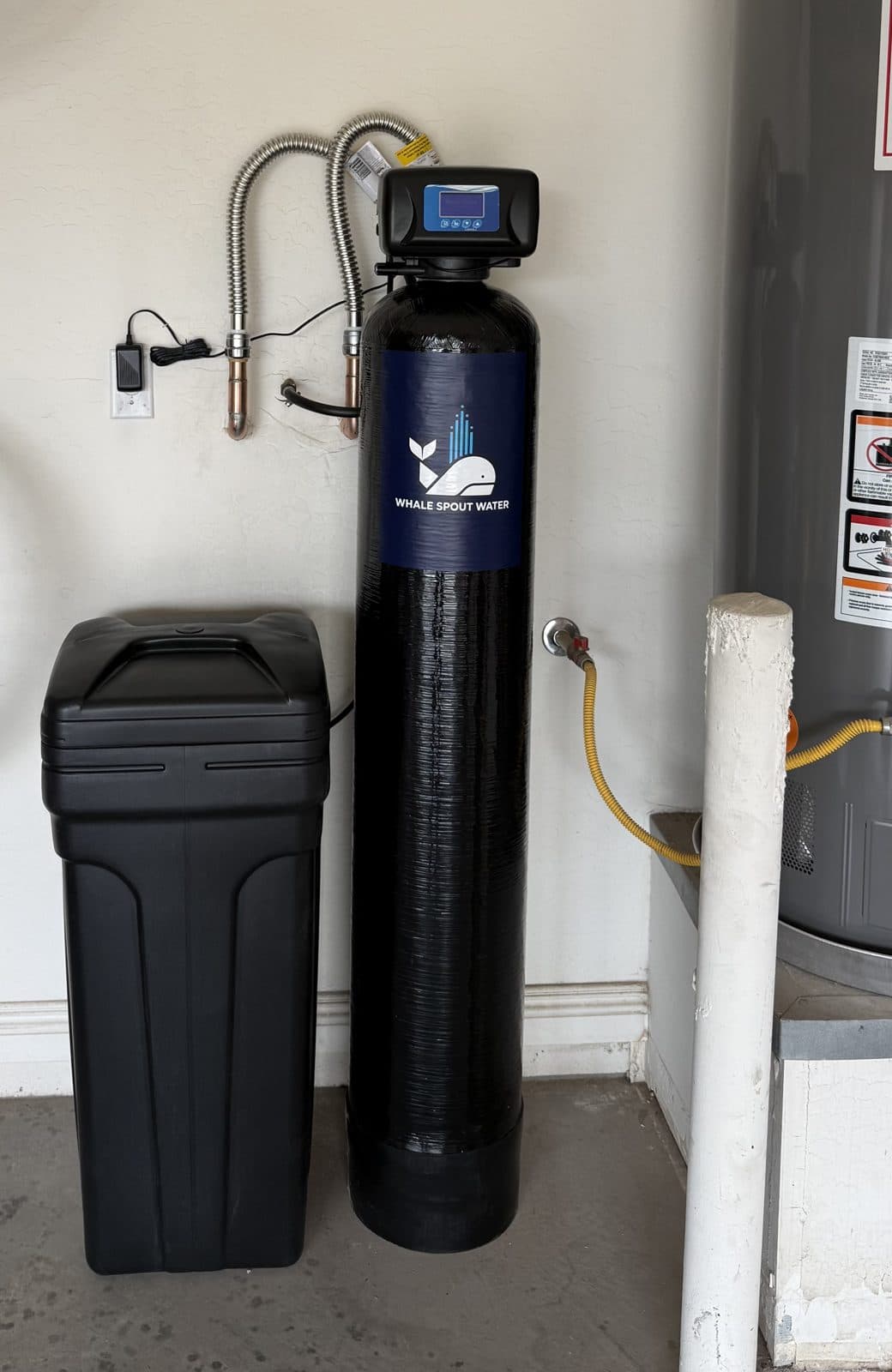 Whole-home water softener resin tank and brine tank installed by Whale Spout Water in a Phoenix-area garage